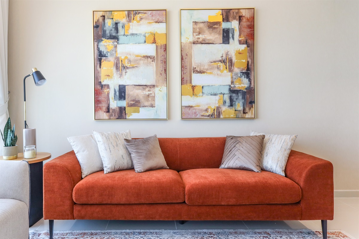 Gallery-worthy art wall anchors a cosy, colour-rich lounge